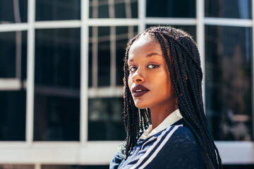African American woman with Afro braids looking at camera