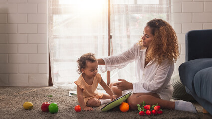 Happy loving young multiracial family African American mother Caucasian father playing with little...