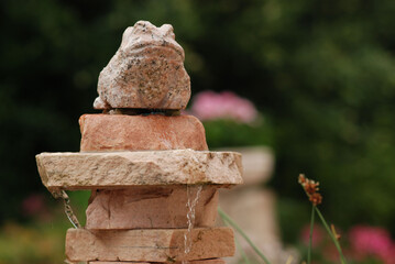 Fountain from natural stones and a frog statue
