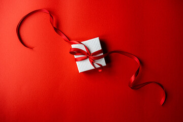 White gift box with red ribbon