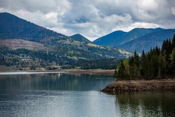 View of lake Colibita surrounded by mountains. Romania.