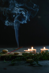 An incense stick that burns and generates smoke.