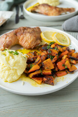 Gluten free dinner with oven baked chicken legs, mashed potatoes and marinated pumpkin salad on a plate