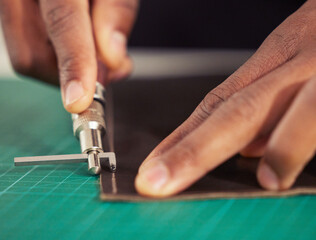 Its hands-on work. an unrecognizable male designer working with leather in his design studio.