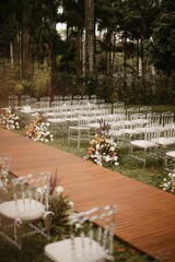 Vertical shot of an outdoor seating arrangement in a garden with floral decorations for a wedding