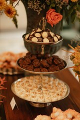 Variety of delicious desserts on trays on a table during a wedding celebration
