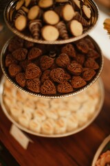 Variety of delicious desserts on trays on a table during a wedding celebration