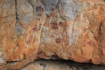 Aged rock featuring prehistoric paintings