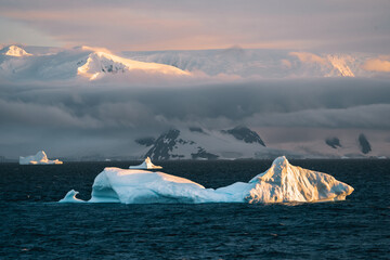 Antarctic Iceberg nature landscape during midnight sun sunset sunrise in the horizon. Early morning...