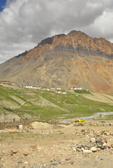 View of a village next to a beautiful rocky mountain with flowing a river in the way of Darcha-Padum road, Ladakh, INDIA.