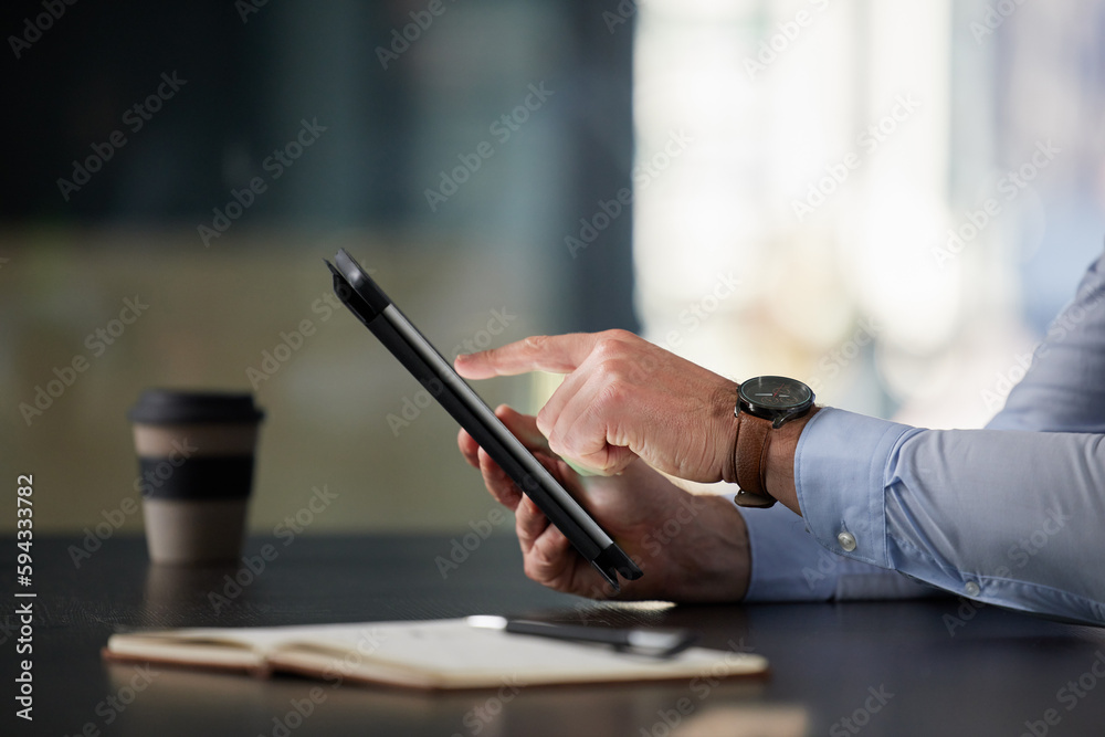 Poster Getting multiple tasks done in an instant. Closeup shot of an unrecognisable businessman using a digital tablet in an office.