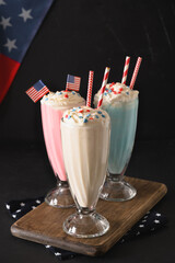 Strawberry and vanilla milkshake for Patriotic Independence Day in USA on black background....