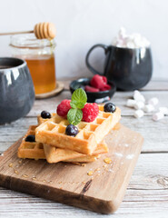 
Belgian waffles with berries. Morning. On a wooden background