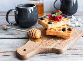 
Belgian waffles with berries. Morning. On a wooden background