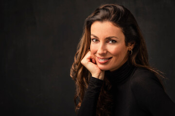 Beautiful brunette haired woman studio portrait against at isolated background