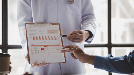 Meeting room in a hospital with a group of doctors attending an informational presentation, a...