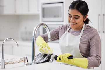 These dishes wont do themselves. a young woman doing the dishes at home.