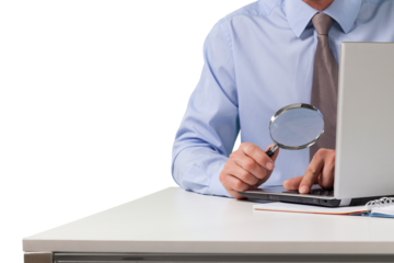 Businessman with Magnifying Glass checking the numbers