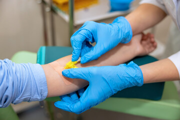 Little girl kid in clinic room having dropper with medication, doctor with drop counter and patient