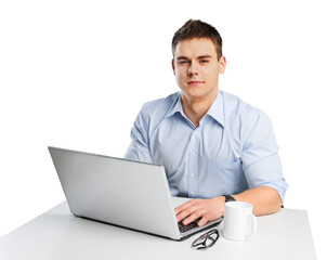 Male student with glasses in front of his laptop