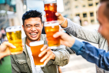 Happy young people drinking and toasting beer together at brewery bar garden outdoors - Beverage...