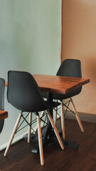 black chair and wooden table in coffee shop, simple coffee shop interior