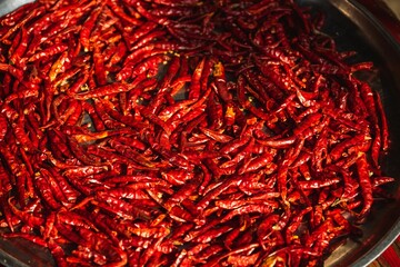 Fototapeta premium Closeup shot of a pan filled with dried red chili peppers