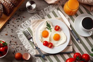 Fried eggs for breakfast. Healthy breakfast with vegetables and herbs. Fried eggs on a white plate. Serving on the table. Morning fried eggs with coffee and orange juice.