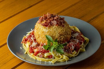 Plate of Italian spaghetti bolognese on a rustic wooden table