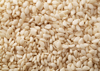 Pile of white sesame seeds as background, top view. Macro. Extreme close up.