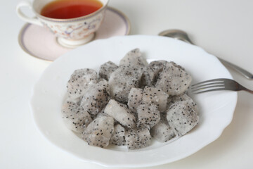 frosted pieces of dragon fruit closeup photo on white background