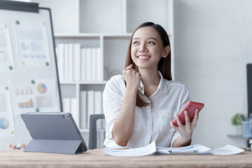 Confident Asian businesswoman calculating finances in the accounting and balance sheet work of the stock market and international exchange rates, Authorized Share Capital, Owners Equity, Common Stock