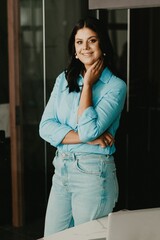 Female professional at her home office, smiling with contentment