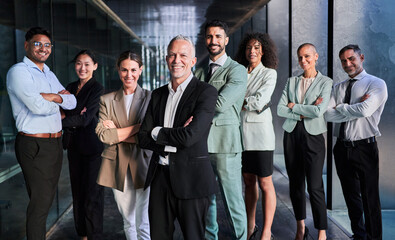 Multicultural business team headed by boss. Posing to camera cheerfully with crossed arms at the...