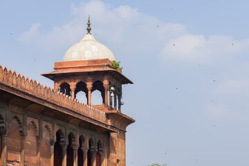 Fototapeta na wymiar Tower of jama masjid, an ancient mosque of Delhi. The historical monument is made of red sandstone and white marble with indo-islamic architecture style. The sentry towers are used for watchkeeping.