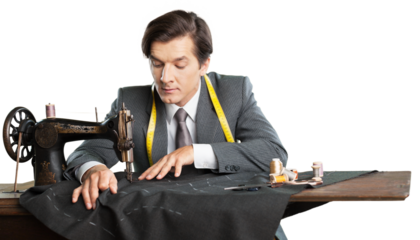 Tailor at work. Confident young tailor sewing clothes at the tailor shop