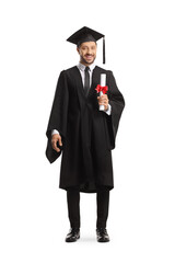 Full length portrait of a smiling man wearing a graduation gown and holding a diploma