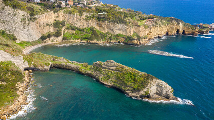 Fototapeta premium Aerial view on the Trentaremi bay of Posillipo, a district of Naples, Italy. There is a small empty beach in a cove. The coast overlooks the Mediterranean Sea.