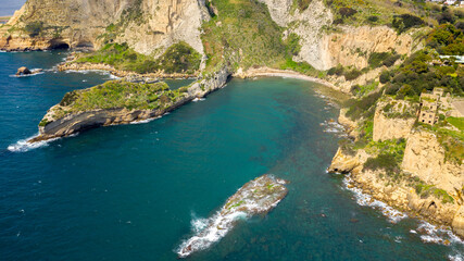 Fototapeta na wymiar Aerial view on the Trentaremi bay of Posillipo, a district of Naples, Italy. There is a small empty beach in a cove. The coast overlooks the Mediterranean Sea.