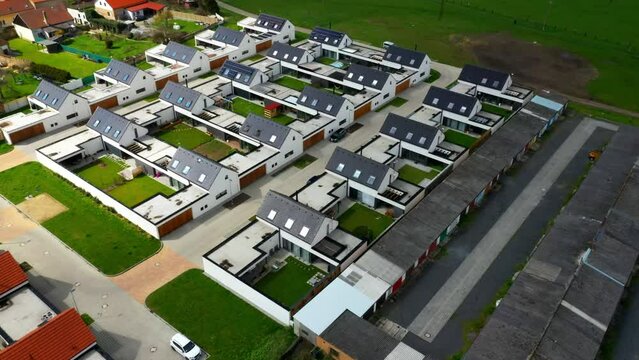 Suburban district houses from above. Passive buildings full of modern technologies for sustainability. Housing for a young progressive generation.	