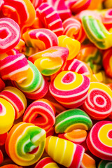 Pile of colorful candies sitting on top of pile of other candies. Generative AI.