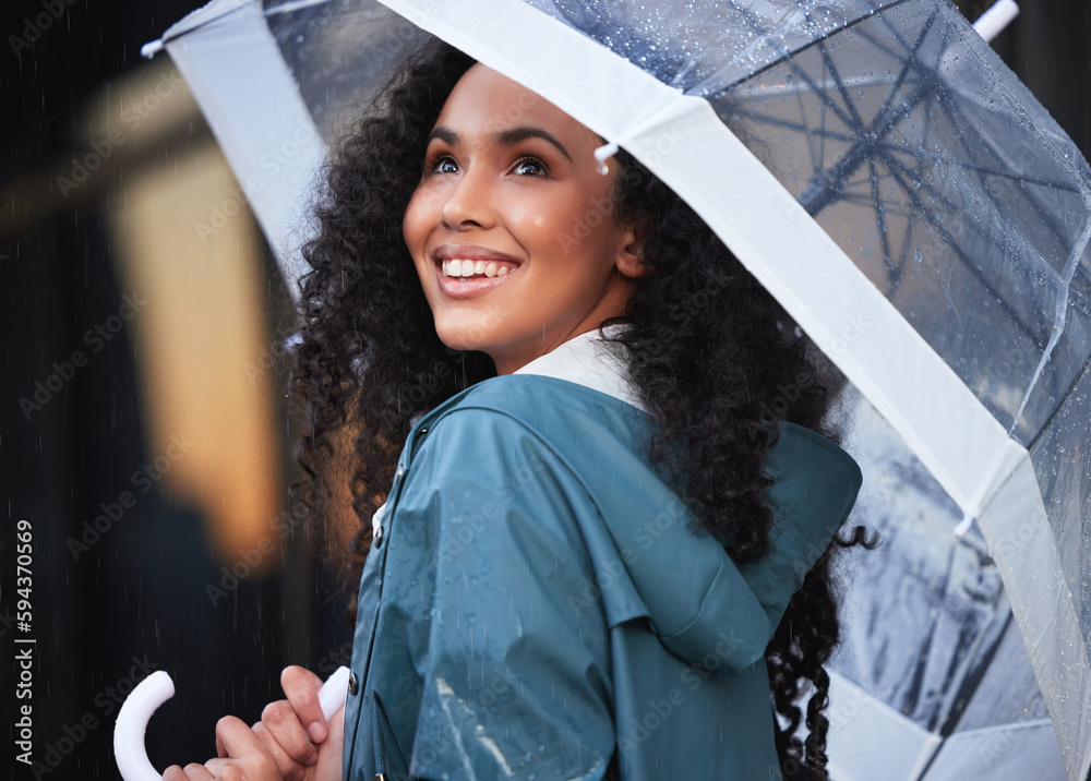 Wall mural take a second to admire the beauty that is the rain. a young woman admiring the rain in the city.