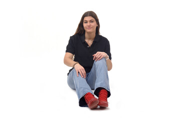 front view of a young girl sitting on the floor looking at camera on white background