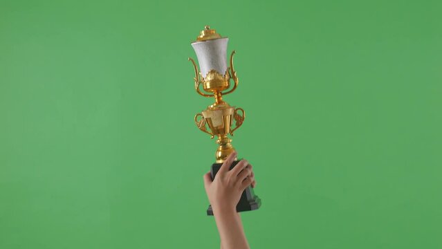 Woman Holding A Champion Golden Trophy. Green Screen Background
