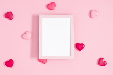 Valentine's day concept. Photo frame, pink hearts on pastel pink background. Love concept. Saint Valentine. Flat lay, top view, copy space
