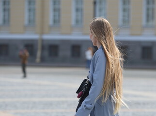 Fototapeta premium Girl with long blonde hair, Palace Square, St. Petersburg, Russia, April 2023