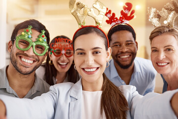 Spreading the festive cheer. Portrait of a group of businesspeople taking selfies together during a...