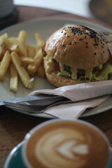 cheeseburger and fried in white plate