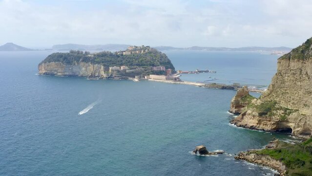 Aerial view of the island of Nisida. It is located in Naples, Italy. Nisida is a volcanic islet of the Flegrean Islands archipelago. It is connected to the city by a long pier.

