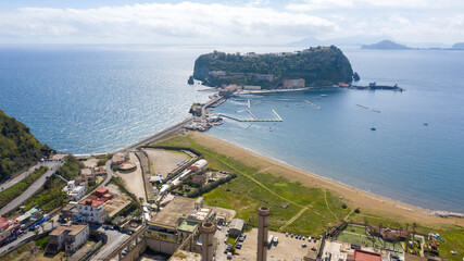 Aerial view of the island of Nisida. It is located in Naples, Italy. Nisida is a volcanic islet of the Flegrean Islands archipelago. It is connected to the city by a long pier. - obrazy, fototapety, plakaty